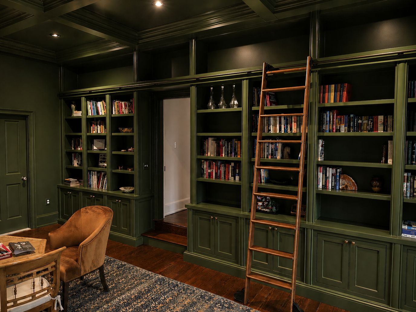 dark green painted cabinets and built-in bookcases