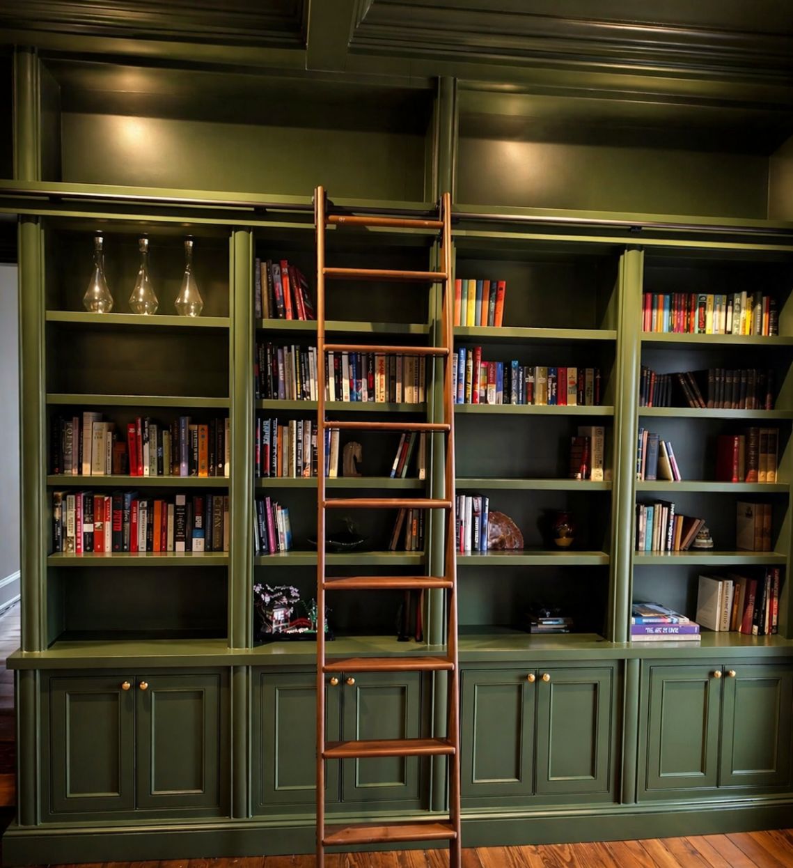 dark green painted cabinets and built-in bookcases