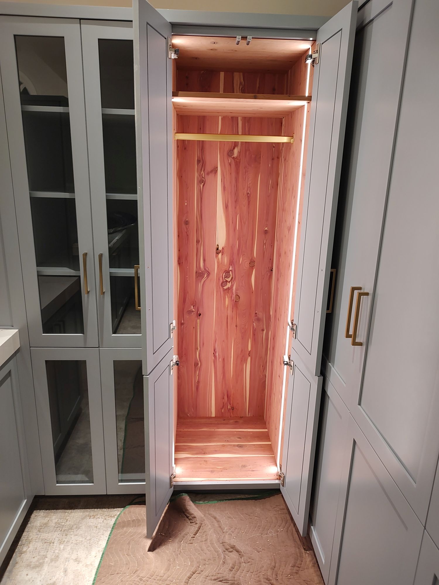 Custom built-in cedar closet with illuminated cedar interior