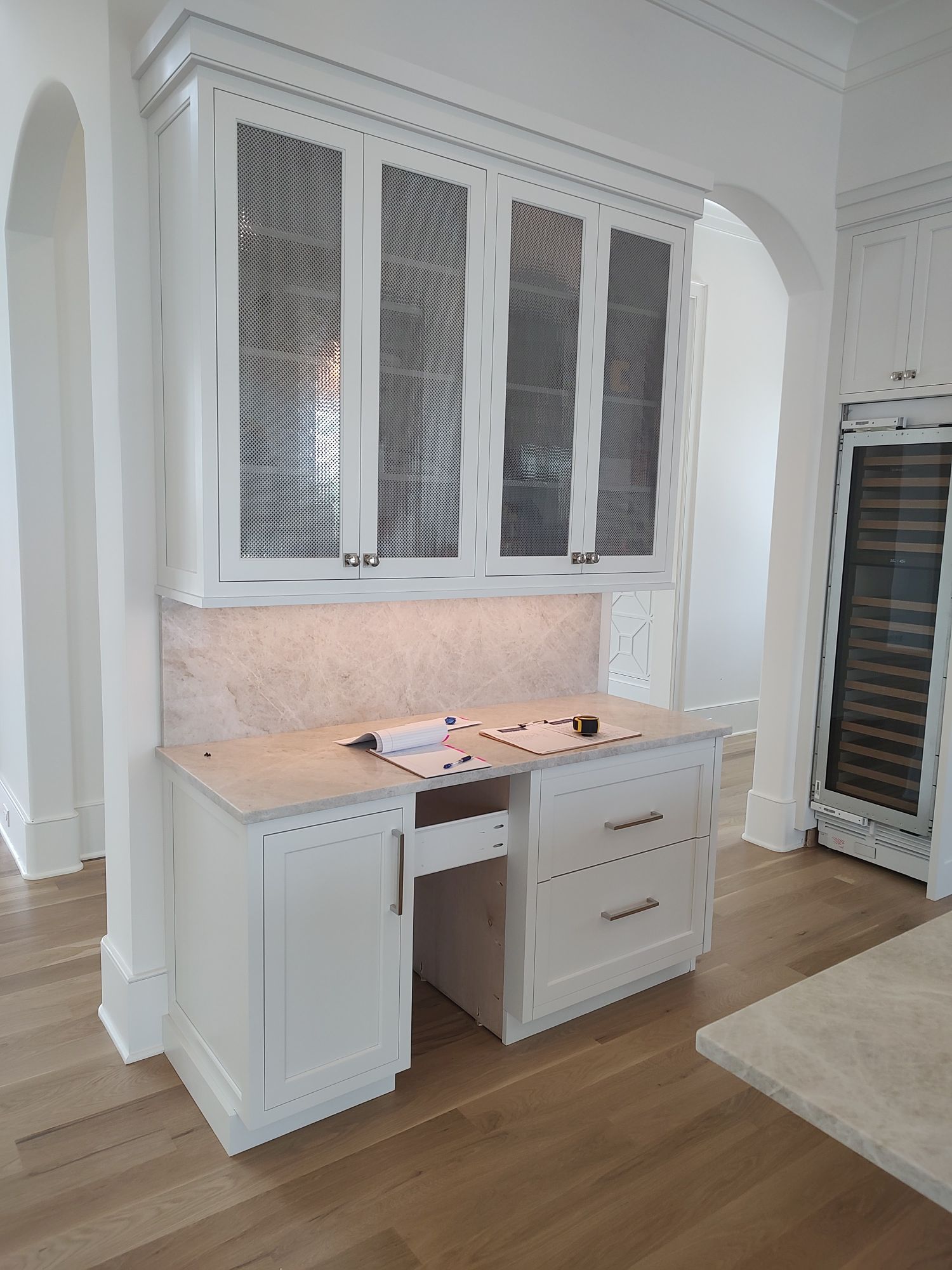 Custom build white cabinets with glass doors